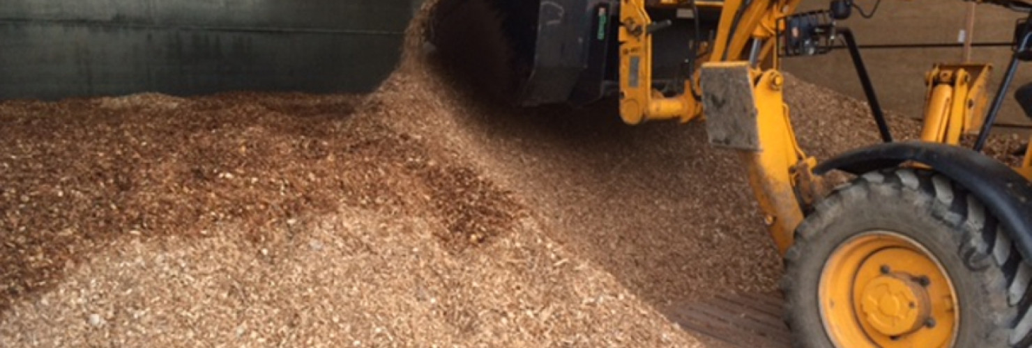 Image of woodchips being moved around by digger at Landplan