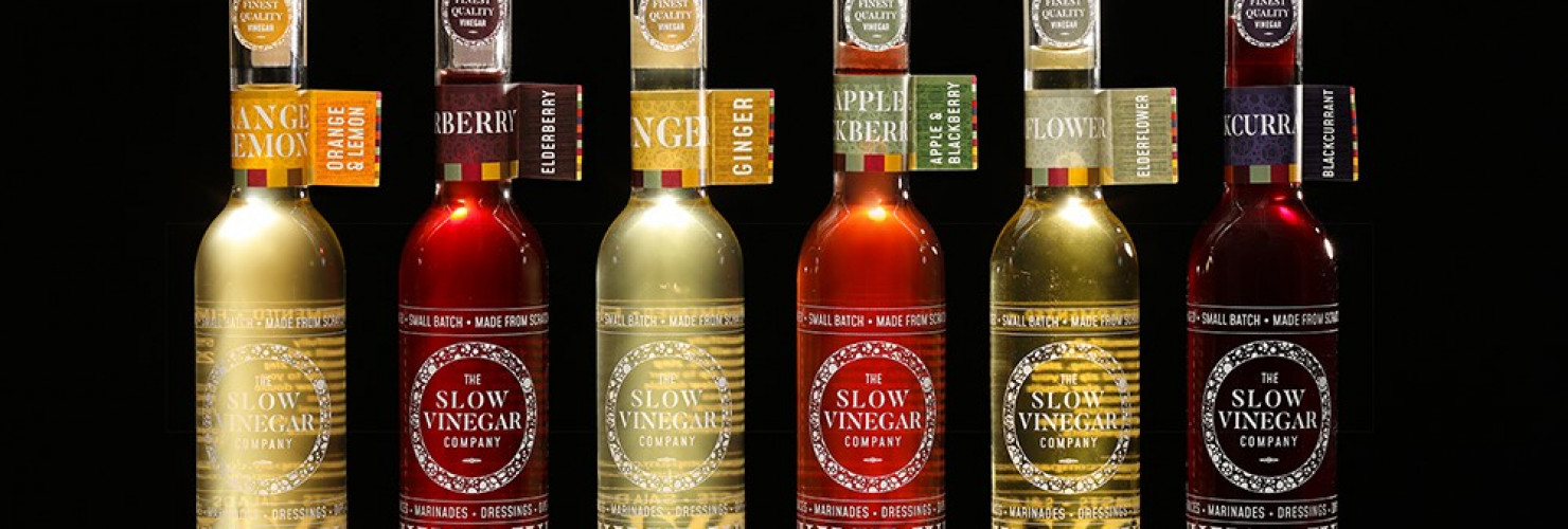 An image of a variety of bottles of flavours of vinegar made by The Slow Vinegar Company