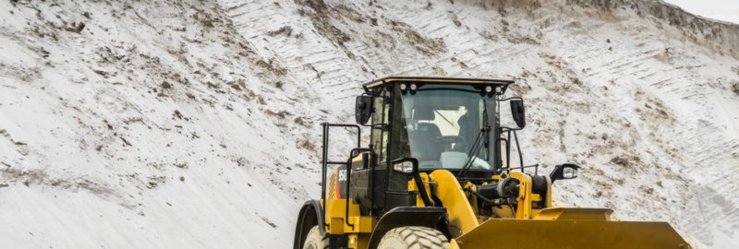An image of a loader next to a pile of sand