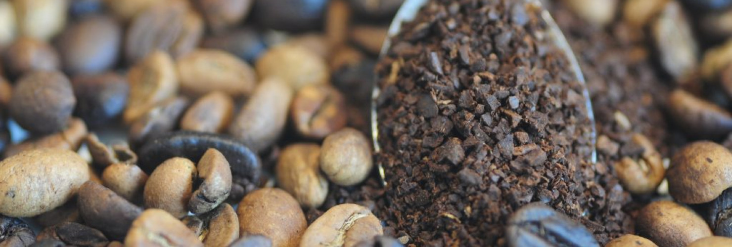 Image of ground coffee and coffee beans