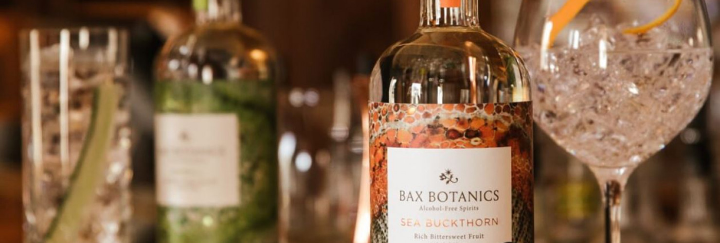 Image of Bax Botanics products next to glasses