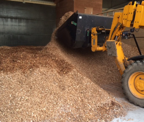 Image of woodchips being moved around by digger at Landplan