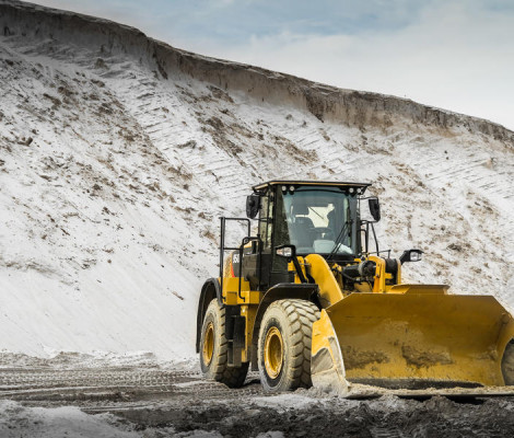 An image of a loader next to a pile of sand